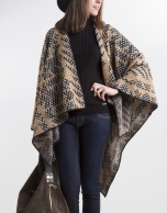 Beige poncho with black trim