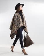 Beige poncho with black trim