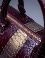 Burgundy leather Carmen Andromeda bag with embossed snake and old gold stripe