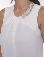 Round neck top with asymmetric beading