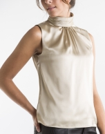 Sandy-colored top with high collar