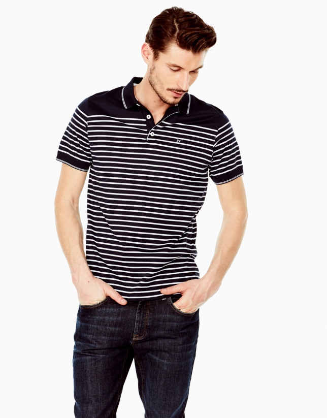 Boy in gray and black stripe polo shirt and blue denim jeans