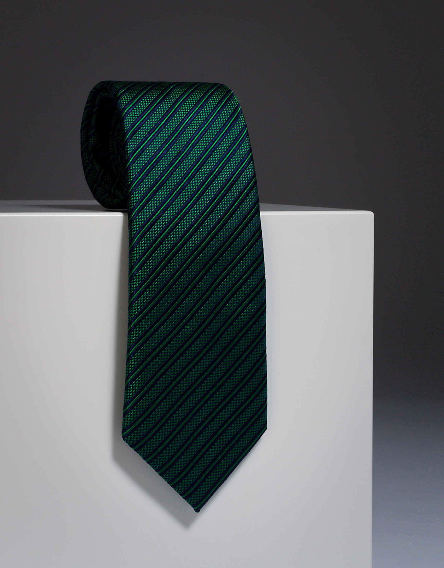 Green silk tie with navy blue stripes