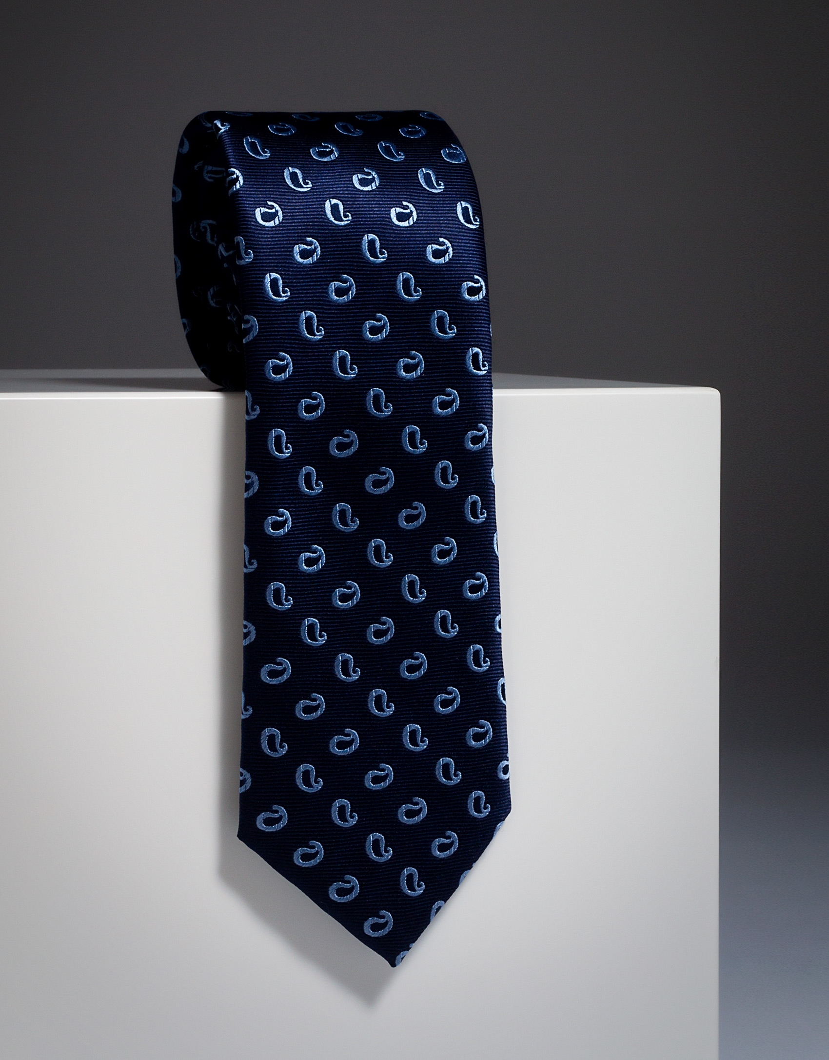 Navy blue silk tie with light blue paisley print