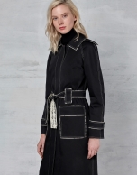 Black trench coat with white stitching