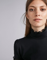 Black short-sleeved top with stovepipe collar