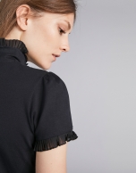 Black short-sleeved top with stovepipe collar