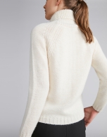 White sweater with stovepipe collar and decoration