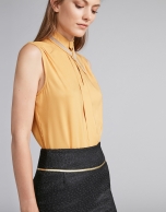 Gold-colored top with decorative collar