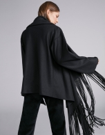 Black cape-effect jacket with fringe