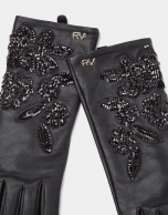 Black leather gloves with print and sequins