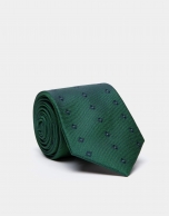 Green silk tie with navy blue geometric jacquard print