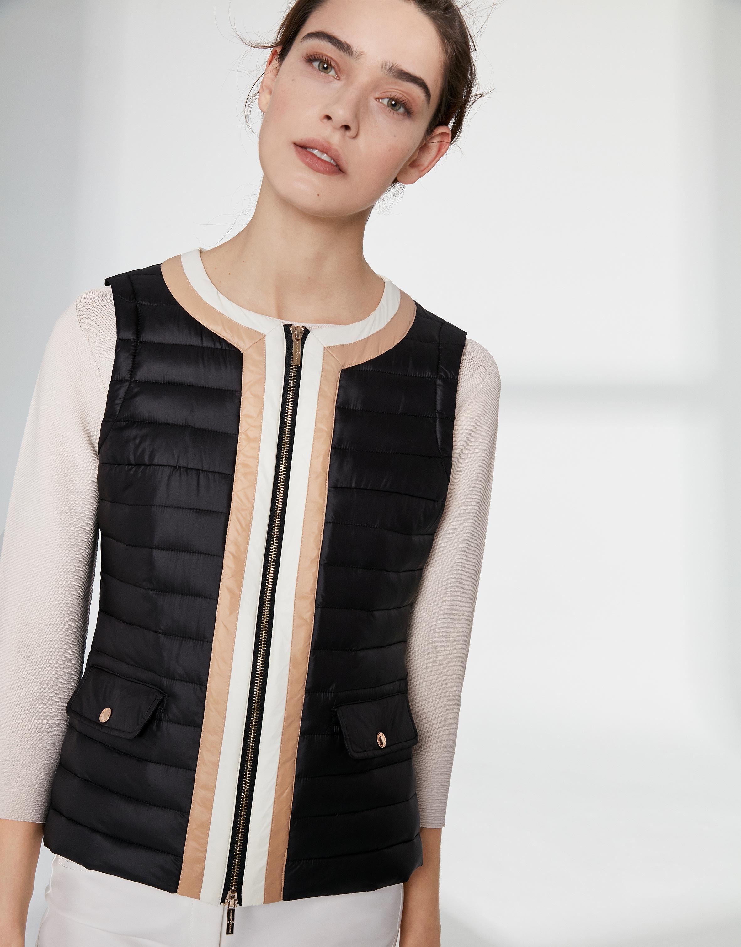 Black quilted vest with contrasting beige