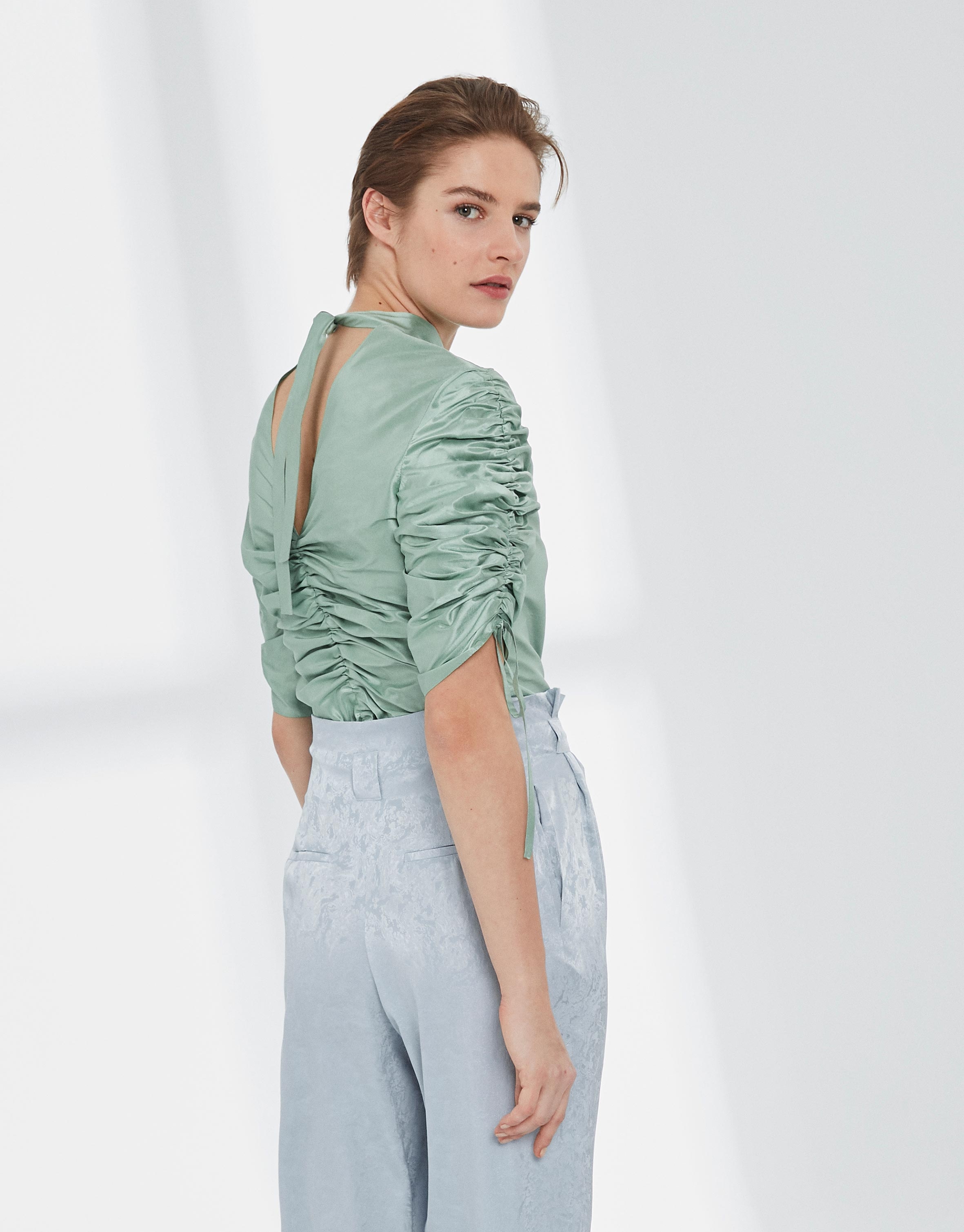 Pastel green silk blouse with puckered sleeves