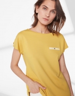 Mustard top with trim on chest