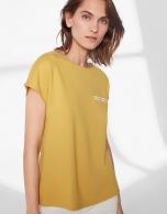 Mustard top with trim on chest