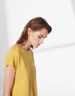 Mustard top with trim on chest