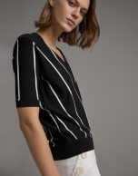 White and black striped sweater and crossover neckline