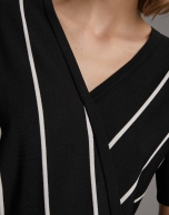 White and black striped sweater and crossover neckline