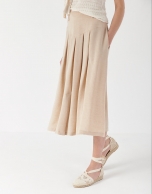 Sand-colored midi skirt with yoke and pleats