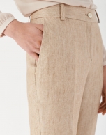 Sand-colored linen pants with turned up cuffs