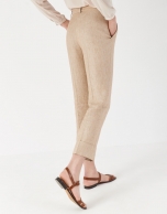 Sand-colored linen pants with turned up cuffs