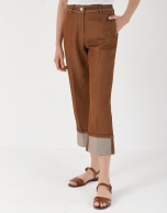 Brown high-waisted pants with turned up cuffs