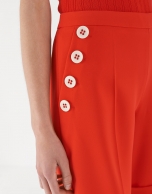 Red shorts with decorative row of buttons