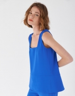 Blue sleeveless top with rounded hem