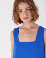 Blue sleeveless top with rounded hem