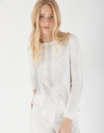 White top with long sleeves and decorative phrasing