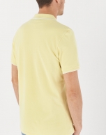 Yellow pique cotton polo shirt with white outlines