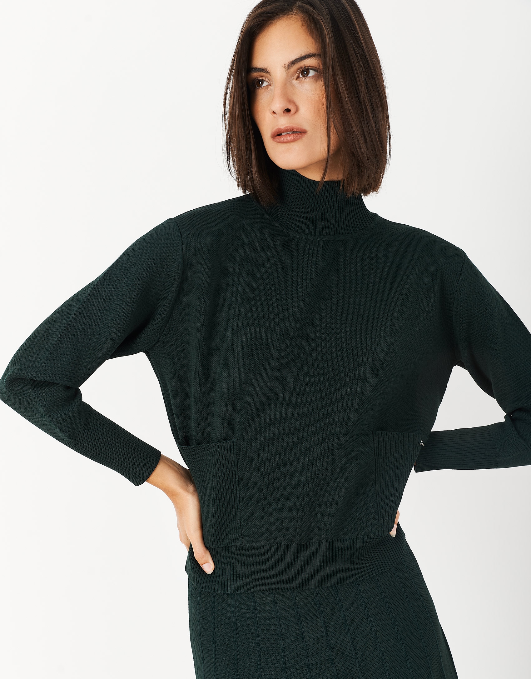 Green sweater with raised collar and pockets