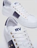 White and blue leather running shoes with studs