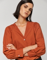 Orange blouse with V-neck and bow