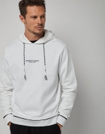 White felt sweatshirt with a design on the chest 