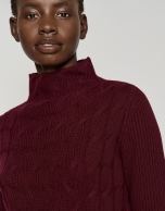 Burgundy sweater with cable stitching and ribbing