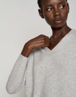 Long light gray sweater with V-neck