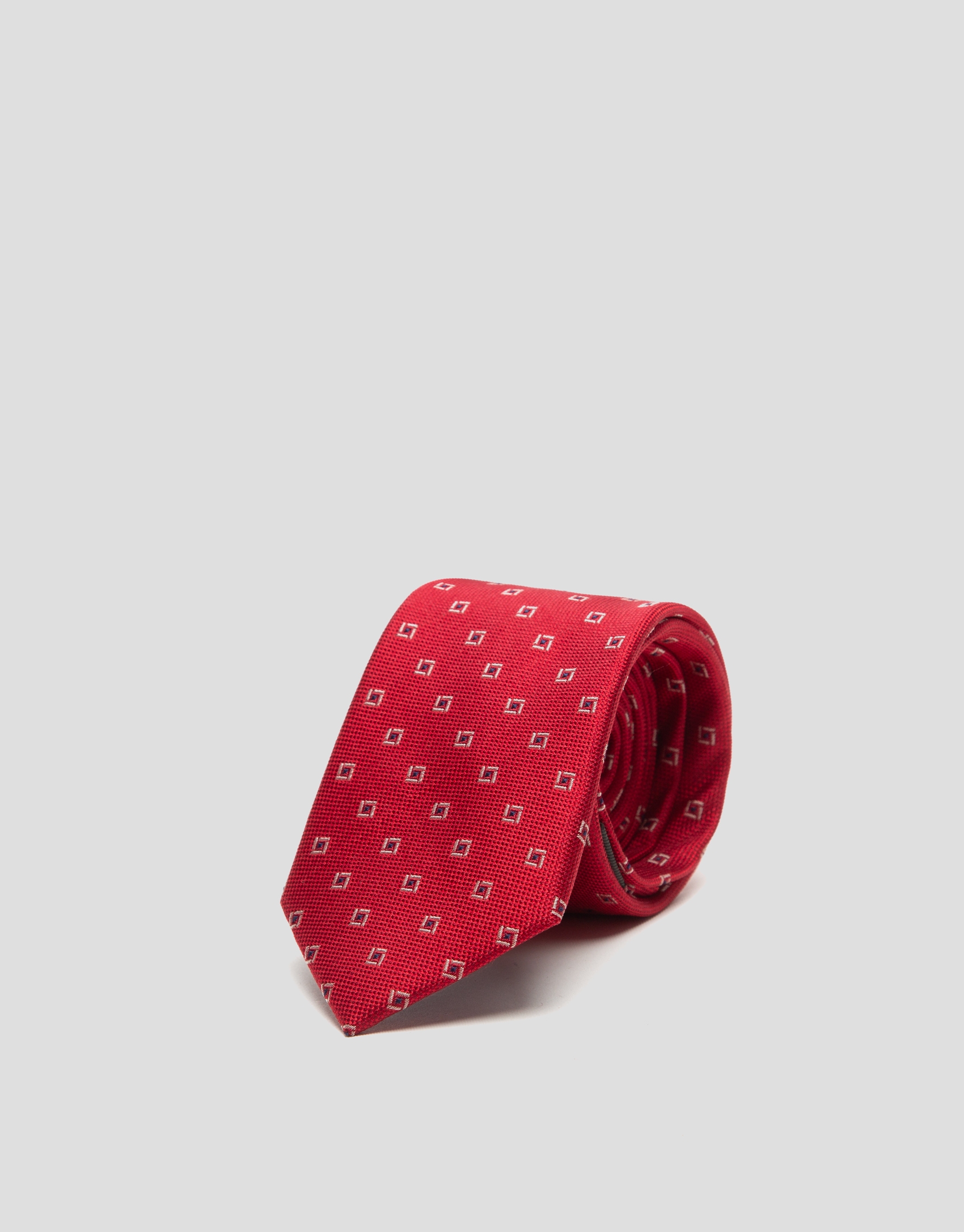 Red silk tie with navy blue and white geometric print jacquard