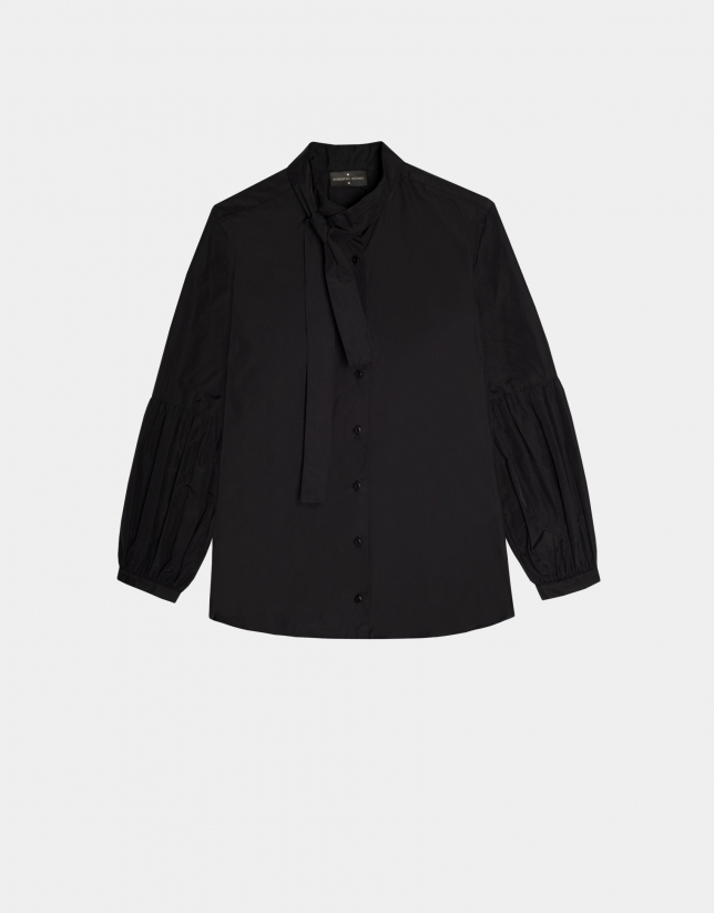 Black blouse with puffed sleeves and a bow