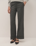 Grey tailored herringbone and discontinuous pinstriped pants with rolled-up hem