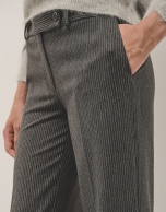 Grey tailored herringbone and discontinuous pinstriped pants with rolled-up hem