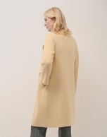 Long straight double-breasted coat in double-faced yellow cloth