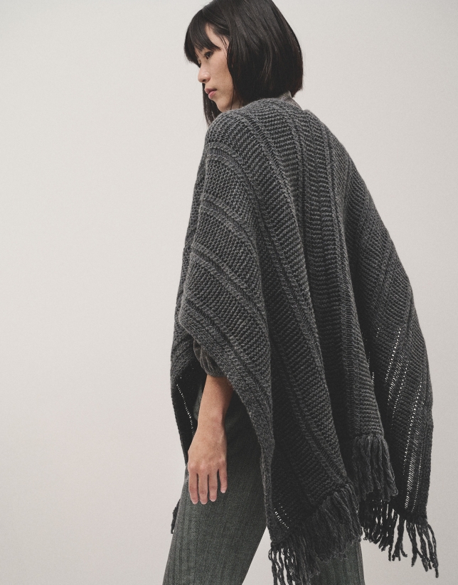 Grey knitted poncho with fringes