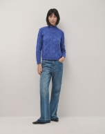 Oversize jumper in a blue chunky cable stitch knitting