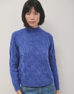 Oversize jumper in a blue chunky cable stitch knitting