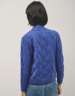 Oversize jumper in a blue chunky cable stitch knitting