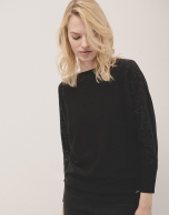 Black knit sweater with strass on shoulders