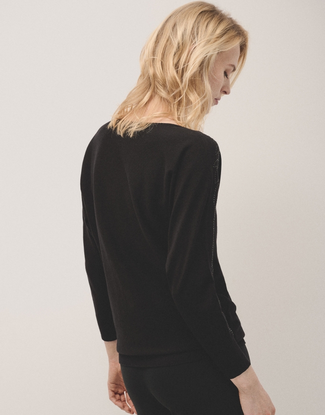 Black knit sweater with strass on shoulders