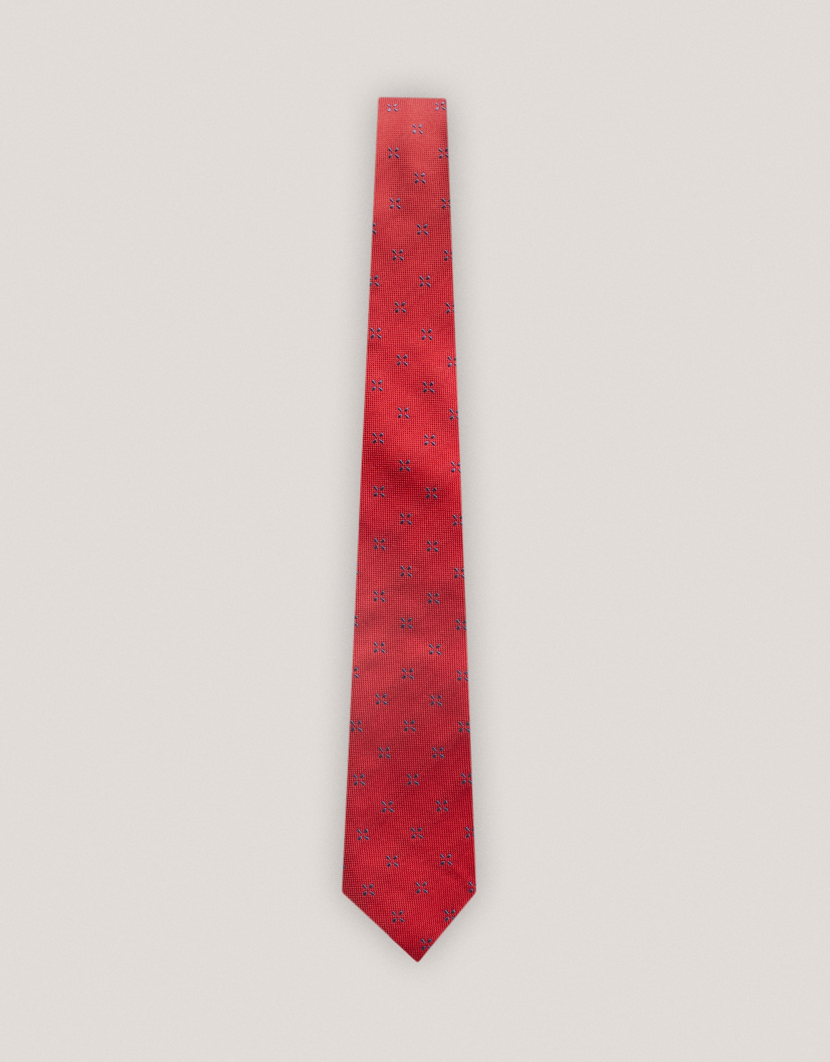 Red silk tie with navy blue floral jacquard